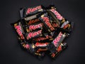 Heap of Mars minis candy bars on black background.