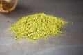 Heap of matcha green tea powder on darck background, close up with copy space