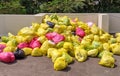 Heap of medical waste bags of different colours containing used PPE suits