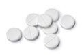 Heap of medical white tablets close up on white background