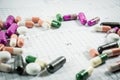 Heap of medicine pills on cardiogram grid paper. Royalty Free Stock Photo