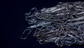 Heap of metal note paper clips on dark background, High details with high contrast Royalty Free Stock Photo