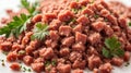 Heap of minced meat with parsley leaves on a white background. Royalty Free Stock Photo