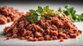 Heap of minced meat with parsley leaves on a white background. Royalty Free Stock Photo