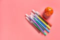 Heap of multi colored felt pens near toy basketball ball lies on pink desk in kindergarten Royalty Free Stock Photo