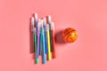 Heap of multi colored felt pens near toy basketball ball lies on pink desk in kindergarten Royalty Free Stock Photo