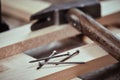 Heap of nails on a freshly planed wood plank Royalty Free Stock Photo