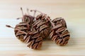 Heap of natural dry tiny pine cones on light brown wooden table, selective focus and blurred background Royalty Free Stock Photo