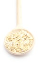 Heap of oatmeal with wooden spoon on white background Royalty Free Stock Photo
