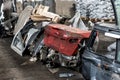 Heap of old rusty disassembled car parts at workshop waste storage hangar indoor. Vehicle salvage dismantling garage Royalty Free Stock Photo