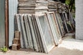 Heap of old wooden window frames with glass outdoors. Broken materials after window energy saving technology upgrade Royalty Free Stock Photo