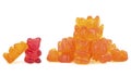 Heap of orange jelly bears candies and one red bear isolated on white background. Gummy bears
