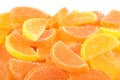 Heap of orange and lemon candy slices on a white Royalty Free Stock Photo