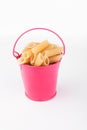 Heap pasta in pink bucket on white background