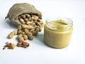 Heap of peanuts in sack bag with peanut butter with copy space. Front view. Royalty Free Stock Photo
