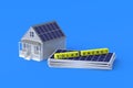 Heap of photovoltaic panels near cubes with inscription solar energy and house
