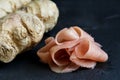 Heap of pickled pink ginger slices isolated on black slate next