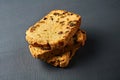 Heap of pieces of tasty sweet homemade bread with raisin lies on dark concrete table on kitchen