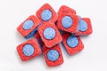 A heap pile of red and blue dishwasher soap tablets on white background Royalty Free Stock Photo