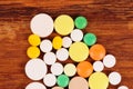 Heap of pills on wooden desk