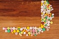 Heap of pills on wooden desk