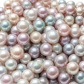 Heap of pink, aqua and peach colored pearls with selective focus - for wedding invitation background or celebration Royalty Free Stock Photo