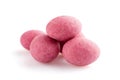 Heap of pink sugared almonds dragees isolated on white background