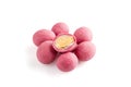 Heap of pink sugared almonds dragees isolated on white background