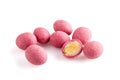 Heap of pink sugared almonds dragees isolated on white background
