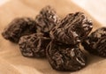 Heap of pitted prunes in linen cloth.