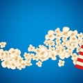 Heap popcorn for movie lies on blue background.