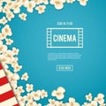 Heap popcorn for movie lies on blue background.