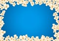 Heap popcorn for movie lies on blue background.