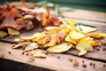 heap of potato skin peels on a rustic wooden board