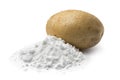 Heap of potato starch and a fresh potato