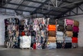 Heap of colorful textile waste packed in bales in store-house