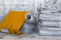 Heap of project drawings in yellow folder. Royalty Free Stock Photo