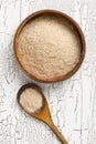 Heap of psyllium husk also called isabgol in wooden bowl and spoon on white table background flat lay from above Royalty Free Stock Photo