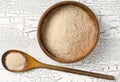 Heap of psyllium husk also called isabgol in wooden bowl and spoon on white table background flat lay from above Royalty Free Stock Photo