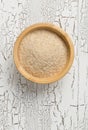 Heap of psyllium husk also called isabgol in wooden bowl on white table background flat lay from above Royalty Free Stock Photo