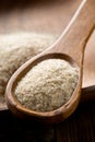 Heap of psyllium husk also called isabgol in wooden spoon and bowl on table Royalty Free Stock Photo