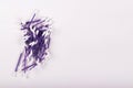 a heap of purple cotton buds on a white background