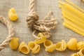 Heap of raw macaroni shells and spaghetti on the organic bagging Royalty Free Stock Photo