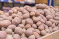 Heap of raw potatoes in a shop. Pile of fresh organic potatoes top view close up. Heap of potato root. Vegetable for mashed potato Royalty Free Stock Photo