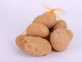 Heap of raw potatoes in yellow string bag Royalty Free Stock Photo