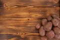 Heap of raw red potatoes on wooden textured background. Fresh vegetables, top view and copy space Royalty Free Stock Photo