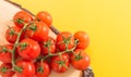 Heap of red cherry tomatoes with stem on wood Royalty Free Stock Photo