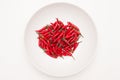 Heap of red hot chili peppers in white plate Royalty Free Stock Photo