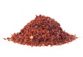 Heap of red pepper flakes isolated on white background. Pile crushed red pepper. Dried chili flakes Royalty Free Stock Photo