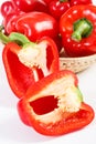 Heap of red peppers with wicker basket on white background, concept of healthy nutrition Royalty Free Stock Photo